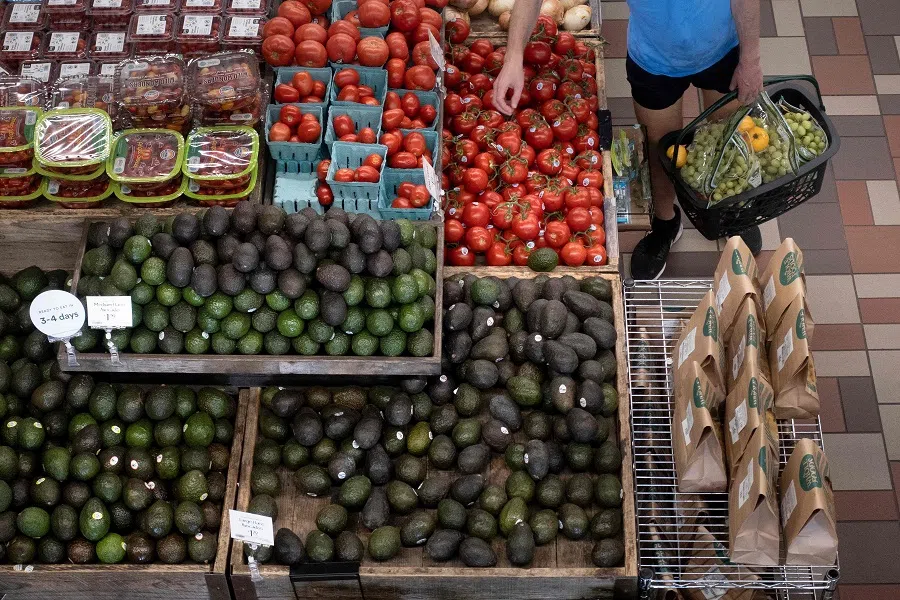 A person shops for produce at an area grocery store on 12 August 2021, in Washington, DC, US. (Brendan Smialowski/AFP)