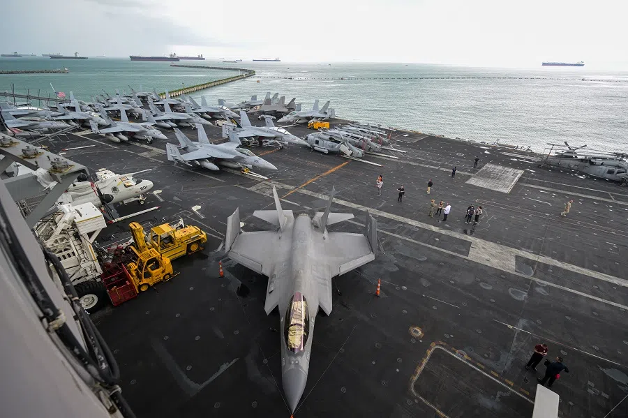 Rows of parked fighter jets and military aircrafts on the flight deck of the USS Carl Vinson during a media tour on 19 December 2023. The vessel, a third Nimitz-class nuclear-powered aircraft carrier, can carry about 60 aircrafts and approximately 5000 personnel. It is one of only 11 operational aircraft carriers in the US Navy today.