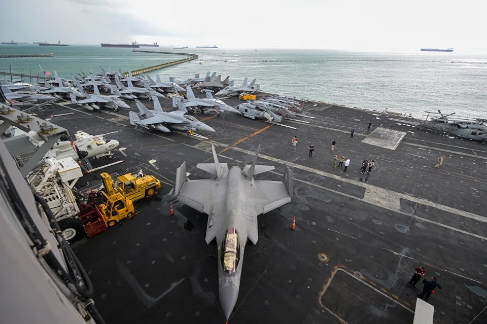 Rows of parked fighter jets and military aircrafts on the flight deck of the USS Carl Vinson during a media tour on 19 December 2023. The vessel, a third Nimitz-class nuclear-powered aircraft carrier, can carry about 60 aircrafts and approximately 5000 personnel. It is one of only 11 operational aircraft carriers in the US Navy today. (SPH Media)