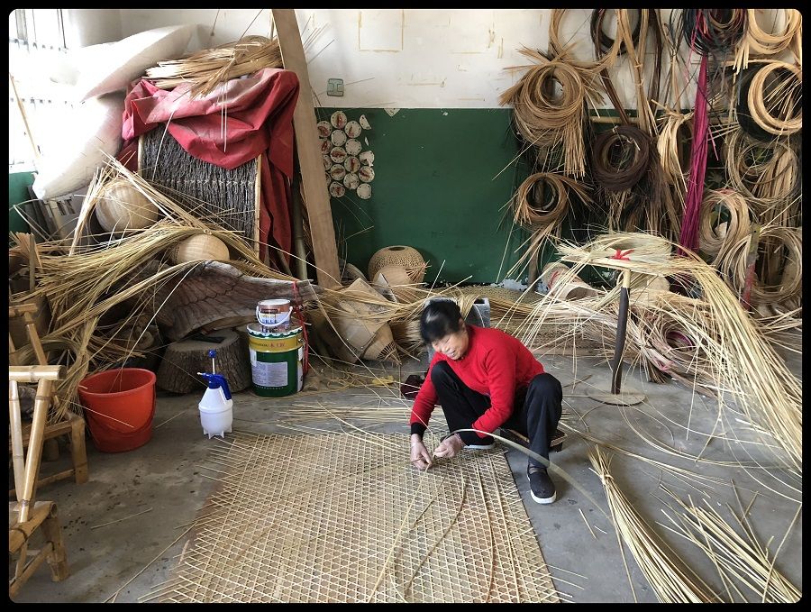 A local villager working in a bamboo workshop in Anji, Zhejiang province, preparing different weave patterns.