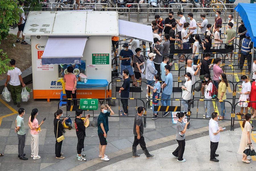 This photo taken on 31 July 2022 shows residents queueing to undergo nucleic acid tests for Covid-19 at a swab collection site in Guangzhou, Guangdong province, China. (AFP)
