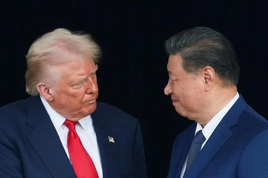 US President Donald Trump and Chinese President Xi Jinping talk as they leave after a bilateral meeting at Gimhae International Airport, on the sidelines of the Asia-Pacific Economic Cooperation (APEC) summit, in Busan, South Korea, on 30 October 2025.