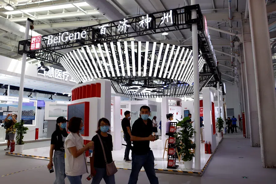 People walk past a booth of biotech company Beigene at the 2021 China International Fair for Trade in Services (CIFTIS) in Beijing, China, on 3 September 2021. (Florence Lo/Reuters)