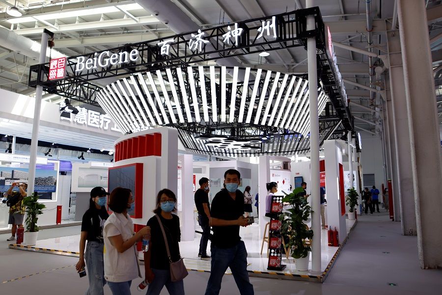 People walk past a booth of biotech company BeiGene at the 2021 China International Fair for Trade in Services (CIFTIS) in Beijing, China, on 3 September 2021. (Florence Lo/Reuters)