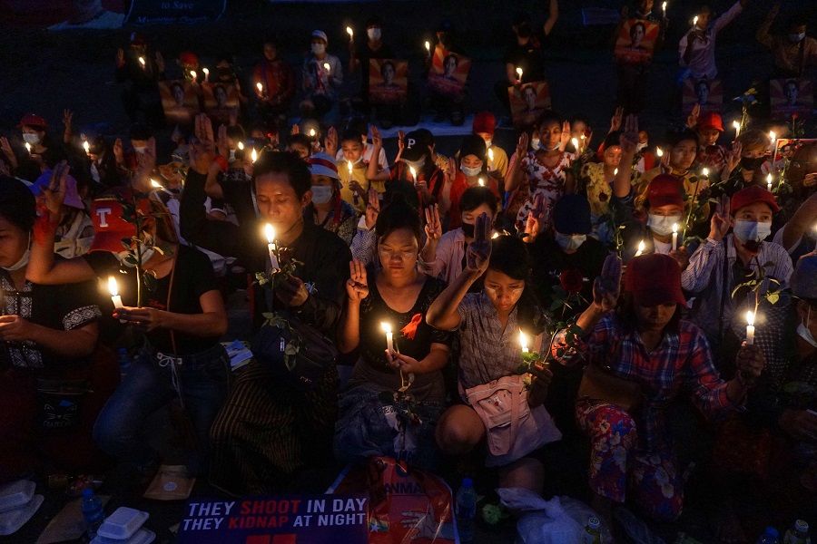 Protesters hold a candlelight vigil outside the US Embassy during a demonstration against the military coup in Yangon, Myanmar, on 21 February 2021. (Sai Aung Main/AFP)