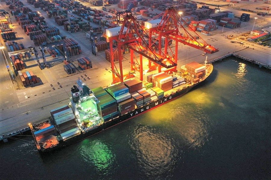 This aerial photo taken on 22 July 2021 shows a cargo ship loaded with containers berthing at Lianyungang port, in Jiangsu province, China. (STR/AFP)