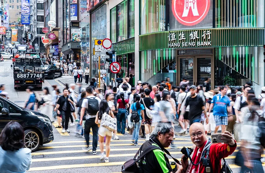 People walk along a street in Central, Hong Kong, on 3 May 2025.