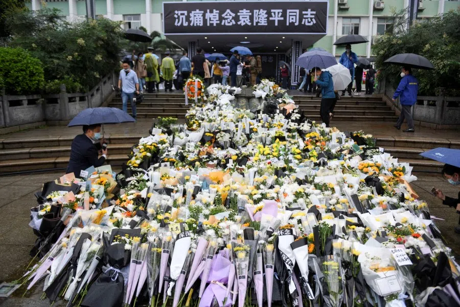 Flowers are laid at a makeshift memorial to mourn Yuan Longping, a Chinese agronomist known for developing the first hybrid rice varieties in the 1970s, at Hunan Hybrid Rice Research Center in Changsha, Hunan province, China 23 May 2021. (cnsphoto via Reuters)