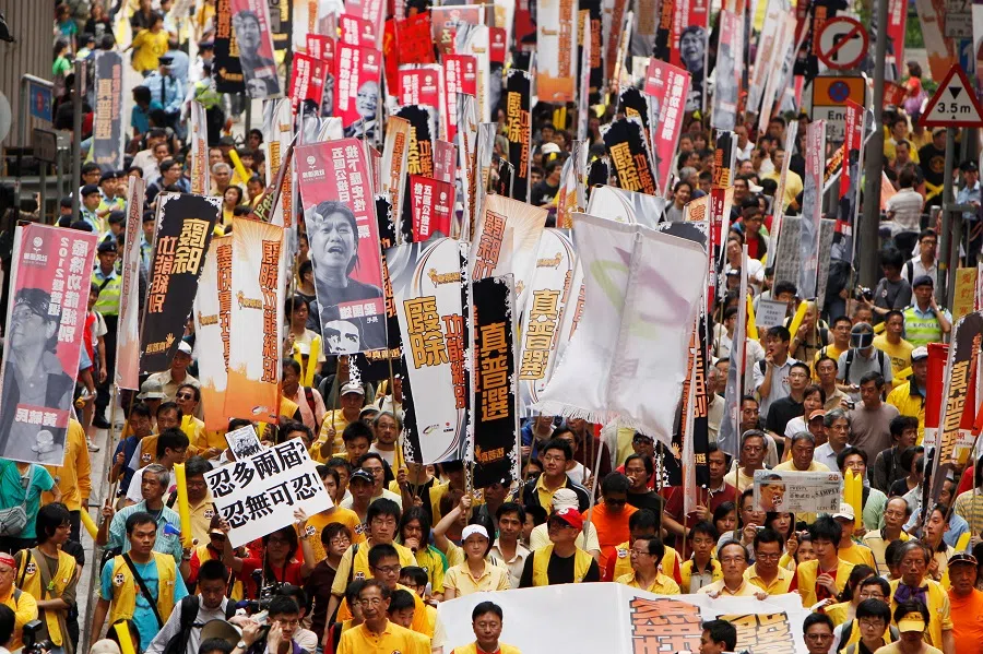 Hundreds of supporters for the referendum campaign take to the streets to demand universal suffrage in Hong Kong, China, on 6 April 2010. (Tyrone Siu/Reuters)