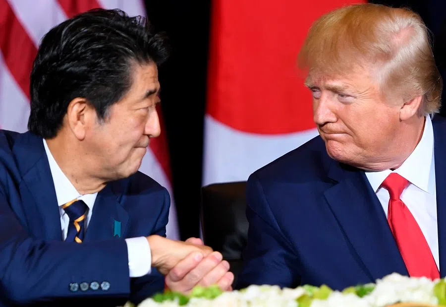 In this file photo taken on 25 September 2019, US President Donald Trump (right) and Japanese Prime Minister Shinzo Abe shake hands during a meeting in New York, on the sidelines of the United Nations General Assembly. (Saul Loeb/AFP)