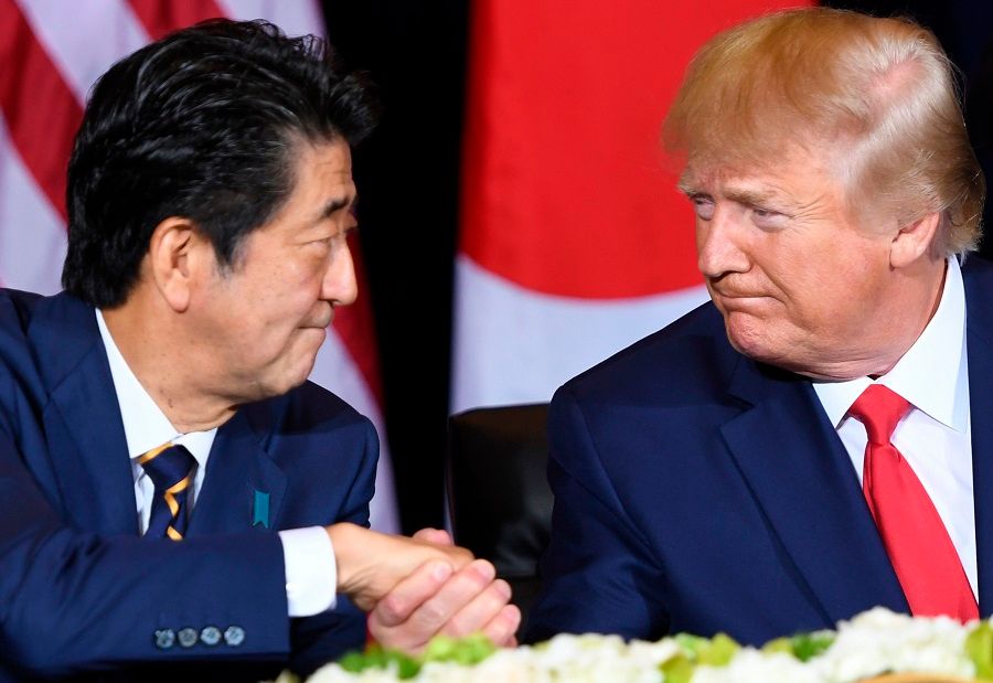 In this file photo taken on 25 September 2019, US President Donald Trump (right) and Japanese Prime Minister Shinzo Abe shake hands during a meeting in New York, on the sidelines of the United Nations General Assembly. (Saul Loeb/AFP)
