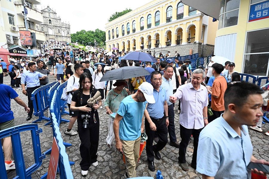 Large crowds of mostly Chinese tourists walk through the historical centre of Macau during the Golden Week holiday on 3 October 2023. (Peter Parks/AFP)