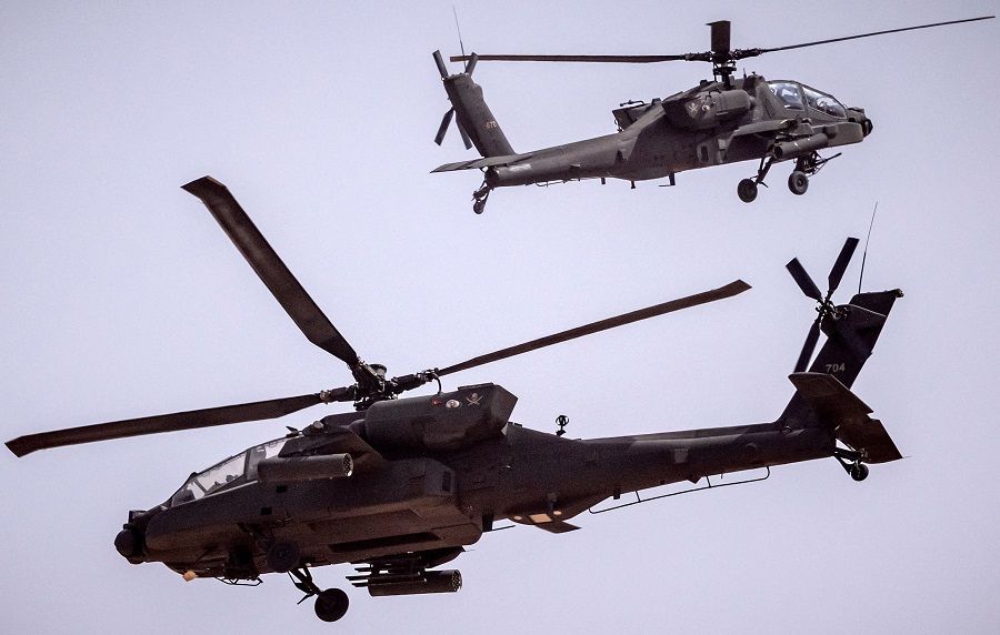 US AH-64 Apache attack helicopters fly over during the second annual "African Lion" military exercise in the Tan-Tan region in southwestern Morocco on 30 June 2022. (Fadel Senna/AFP)