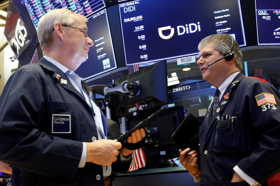 Traders work during the IPO for Chinese ride-hailing company Didi Global Inc on the New York Stock Exchange (NYSE) floor in New York City, US, 30 June 2021. (Brendan McDermid/Reuters)
