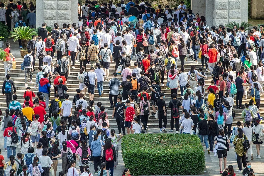This file photo taken on 7 July 2020 shows students arriving at a school to take the gaokao, in Nanjing, Jiangsu province, China. (STR/AFP)