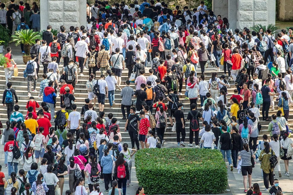 This file photo taken on 7 July 2020 shows students arriving at a school to take the gaokao, in Nanjing, Jiangsu province, China. (STR/AFP)