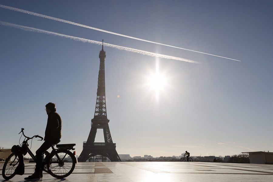A man rides an electric bike in front of the Eiffel Tower, on the Trocadero plaza in Paris, France, on 18 November 2020. (Ludovic Marin/AFP)