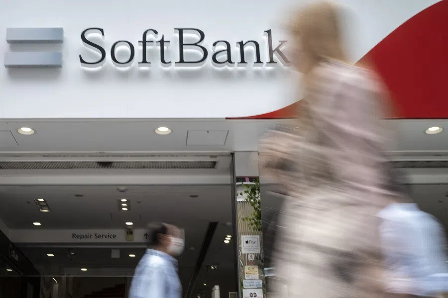 Pedestrians walk past a SoftBank mobile shop in Tokyo, Japan, on 12 May 2022. (Charly Triballeau/AFP)
