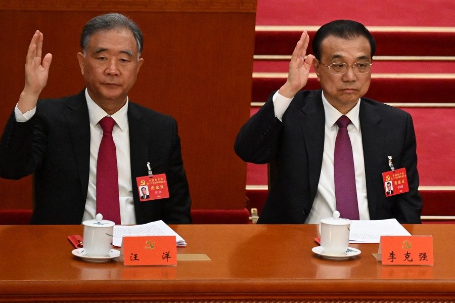 Politburo Standing Committee member Wang Yang (left) and China's Premier Li Keqiang attend the closing ceremony of the 20th Party Congress at the Great Hall of the People in Beijing, China, on 22 October 2022. (Noel Celis/AFP)