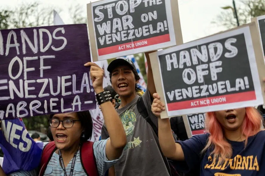 Activists holding placards march towards the US embassy during an anti-US protest following its attack on Venezuela, capturing its President Nicolás Maduro and his wife Cilia Flores, in Manila, Philippines, on 5 January 2026. (Eloisa Lopez/Reuters)