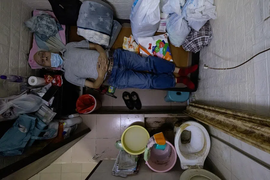 Wong Chi-kong, 76, poses for a photo inside his 50 sq ft subdivided unit in Hong Kong, China, on 8 August 2024. (Tyrone Siu/Reuters)