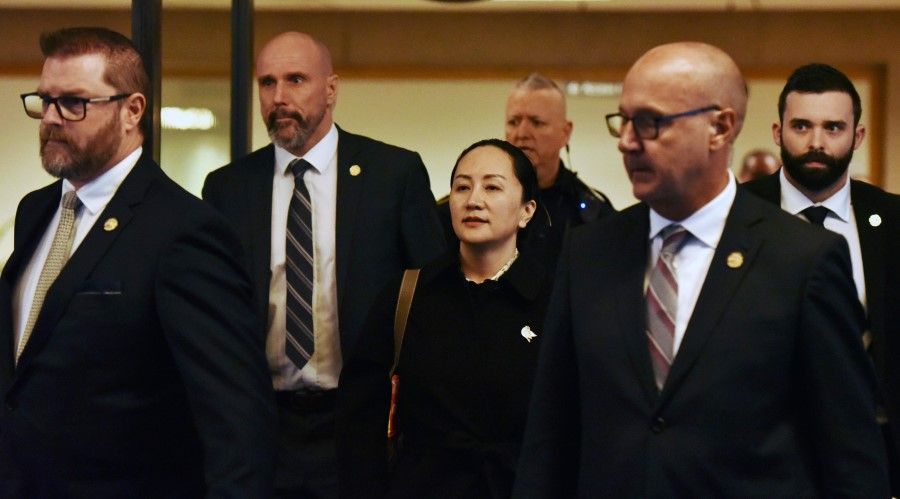 Huawei CFO Meng Wanzhou leaves British Columbia Supreme Court with her security detail on January 23, 2020 in Vancouver, British Columbia. Supreme Court judge adjourned proceedings over whether or not to send Meng to the US to face fraud charges, effectively leaving Meng in limbo, as no date was set for a decision.