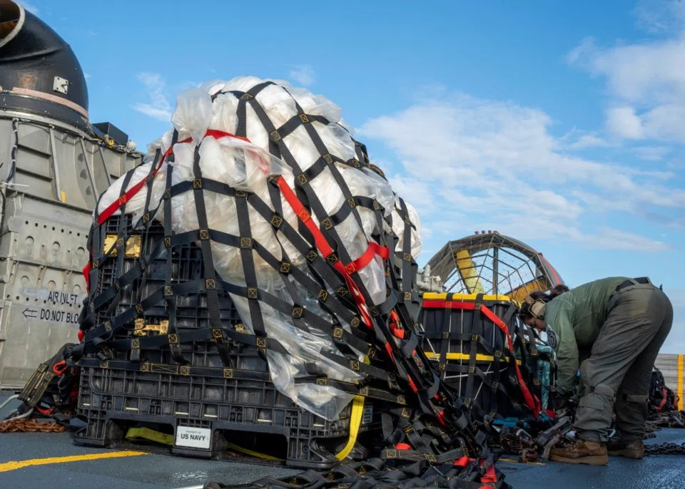 US Navy sailors assigned to Assault Craft Unit 4 prepare material recovered in the Atlantic Ocean from a high-altitude Chinese balloon shot down by the US Air Force off the coast of South Carolina after docking in Virginia Beach, Virginia for transport to federal agents at Joint Expeditionary Base Little Creek on 10 February 2023 in this image released by the US Navy in Washington, US, 13 February 2023. (Mass Communication Specialist 1st Class Ryan Seelbach/US Navy/Handout via Reuters)