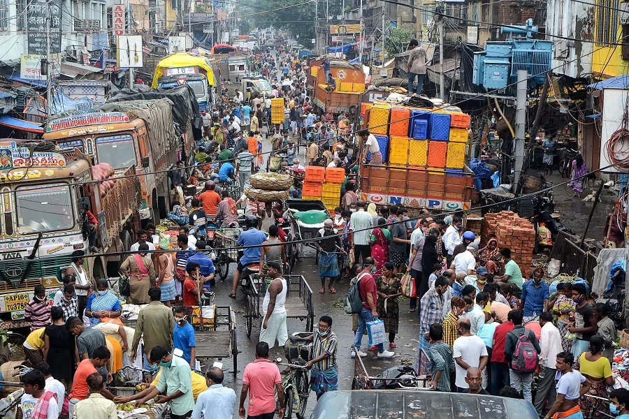 People shop at a wholesale vegetable market in Kolkata, India on 20 June 2021 after West Bengal's state government eased lockdown restrictions to curb the spread of the Covid-19 coronavirus. (Mainak Bagchi/AFP)