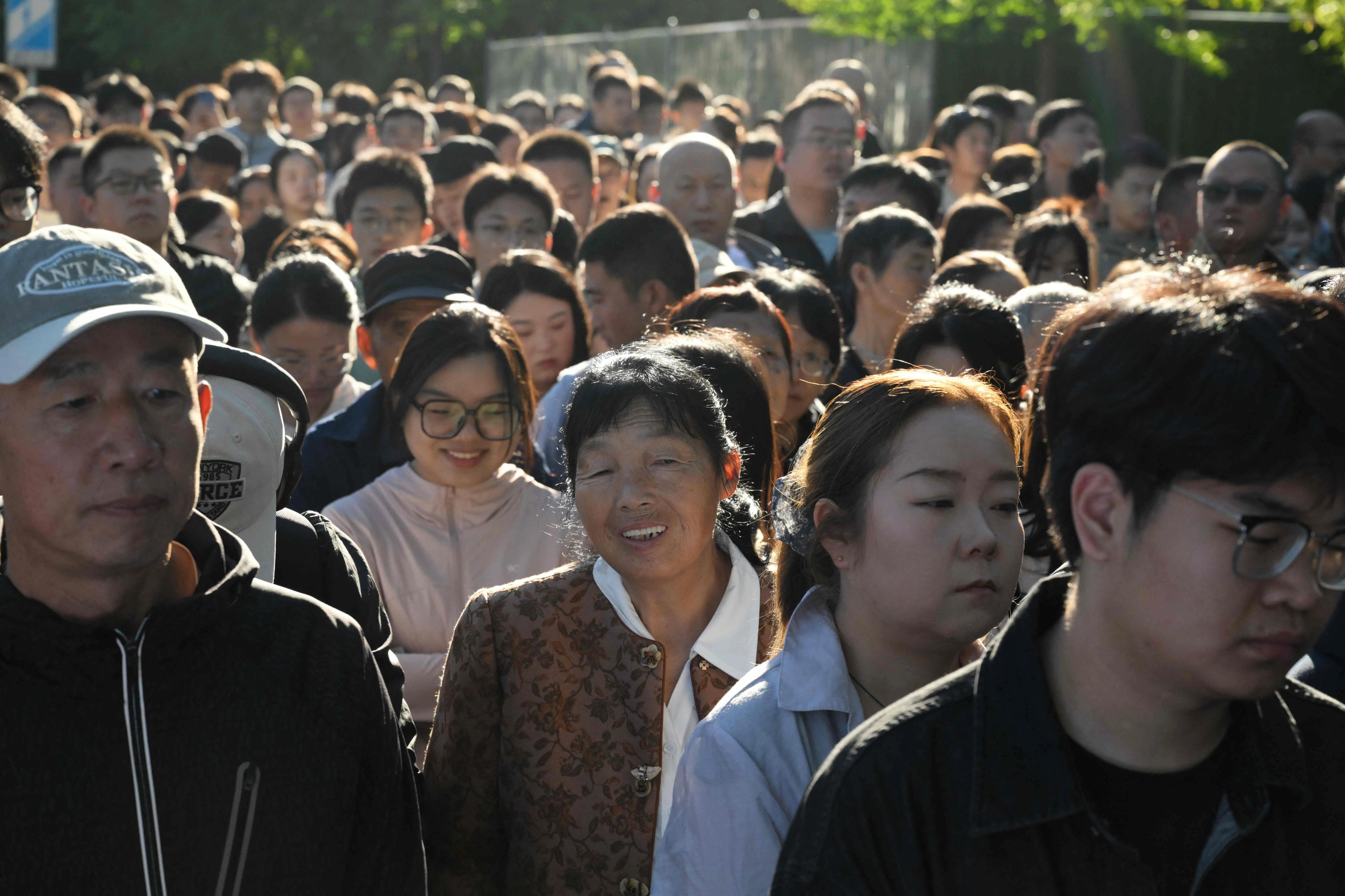 People line up in a street near Tiananmen Square as they wait to go through security to enter the square on China’s National Day, which marks the anniversary of the founding of the People’s Republic of China, in Beijing on 1 October 2026.