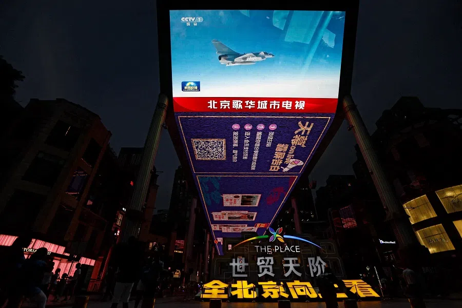 A screen broadcasts news footage of an Air Force aircraft taking part in military drills by the Eastern Theatre Command of China's People's Liberation Army (PLA) around Taiwan, in a shopping area in Beijing, China, on 19 August 2023. (Tingshu Wang/Reuters)