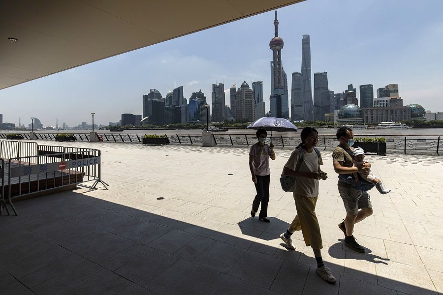 Pedestrians along the North Bund area in Shanghai, China, on 18 June 2022. (Qilai Shen/Bloomberg)
