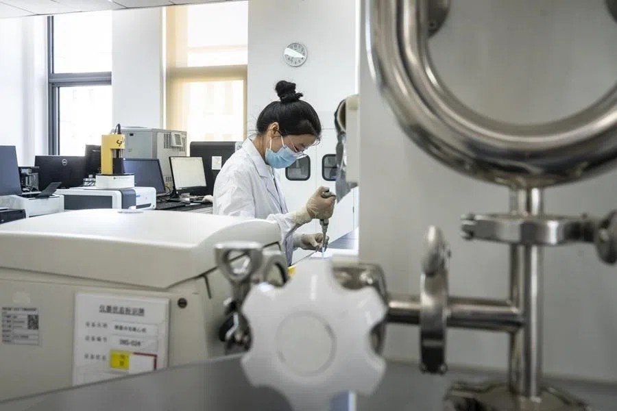 A researcher handles apparatus inside a laboratory at Huahui Health Ltd. in Beijing, China, on 30 May 2026.