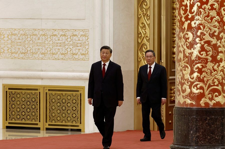 New Politburo Standing Committee members Xi Jinping (left) and Li Qiang arrive to meet the media following the 20th Party Congress of the Communist Party of China, at the Great Hall of the People in Beijing, China, 23 October 2022. (Tingshu Wang/Reuters)