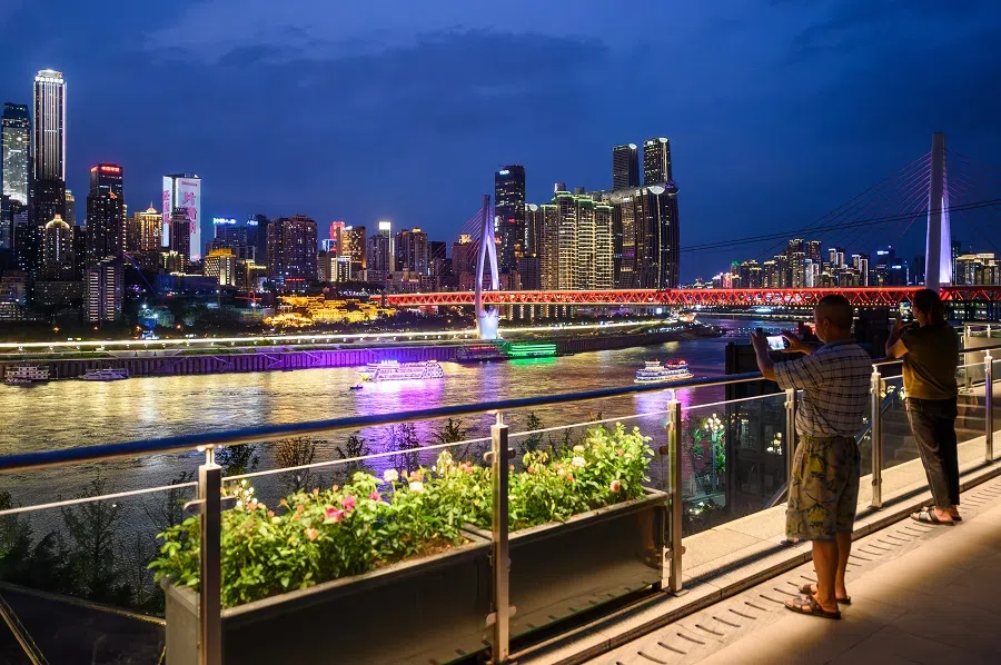 People watching the night view of the city in the Chongqing Open Port Relics Park, Chongqing, China. (China News Agency/He Penglei)