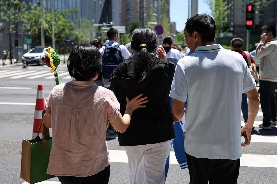 Parents walk with their daughter after the first exam as part of the gaokao, in Beijing, China, on 7 June 2026.