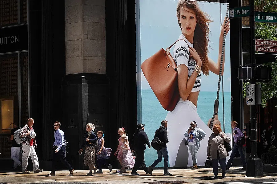 People walk along Michigan Avenue in the Magnificent Mile shopping district on 30 May 2024 in Chicago, Illinois. (Scott Olson/Getty Images/AFP)