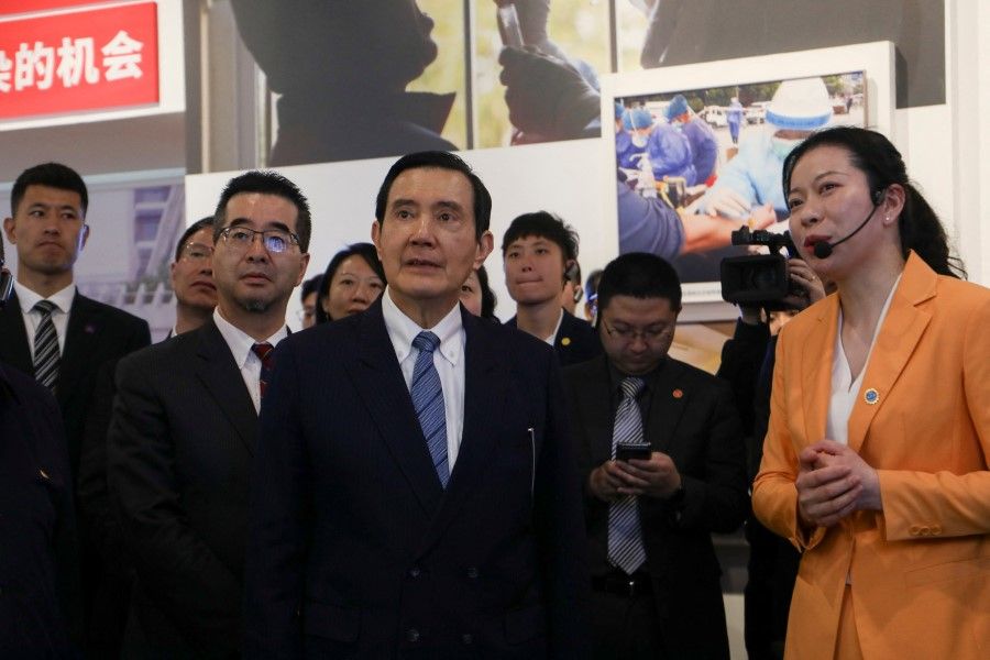 Former Taiwan President Ma Ying-jeou (centre, in blue tie) visits an exhibition on how China fought against Covid-19, in Wuhan, Hubei province, China, in this handout picture released 30 March 2023. (Ma Ying-jeou's Office/Handout via Reuters)