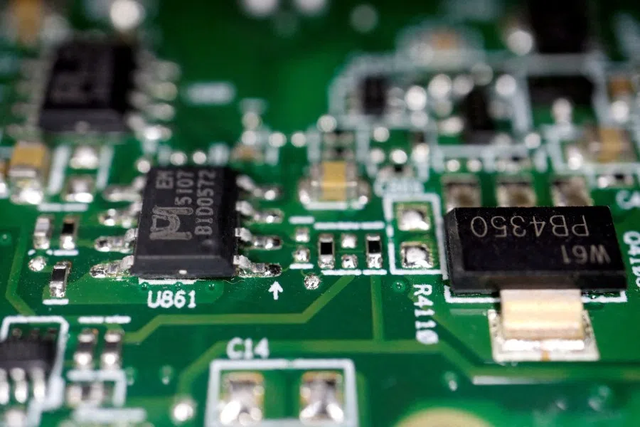 Semiconductor chips are seen on a printed circuit board in this illustration picture taken 17 February 2023. (Florence Lo/Reuters)