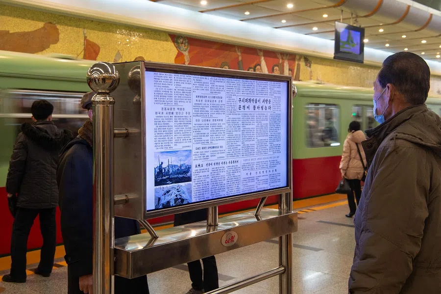 A man reads North Korea’s Rodong Sinmun newspaper, which includes an article (centre, 2nd from bottom) on the inauguration of US President Donald Trump, on a digital monitor displayed in the Kaeson station of the Pyongyang Metro in Pyongyang on 22 January 2025. (Kim Won Jin/AFP)
