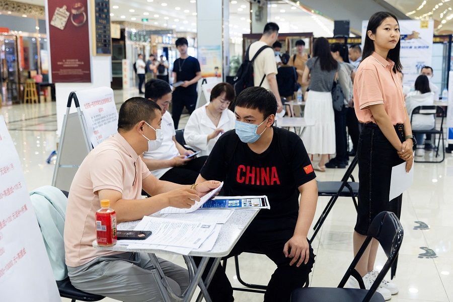 People attend a job fair in a mall in Beijing, China, on 30 June 2023. (Thomas Peter/File Photo/Reuters)