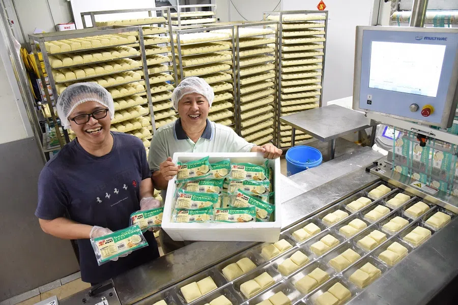 Tan Eng Huat (right) and his son have modernised the tau kwa business.
