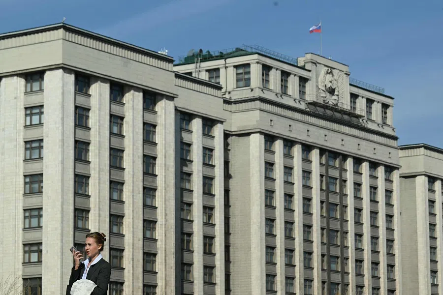 A woman walks past the building of the Russian State Duma (lower house of the Parliament) in central Moscow on 24 September 2024. (Natalia Kolesnikova/AFP)