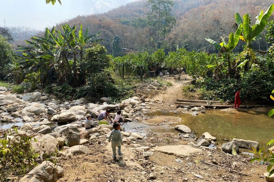 A child walks towards a nature protection zone at Mandian village in Xishuangbanna Dai Autonomous Prefecture, Yunnan province, China, 29 January 2021. (David Stanway/Reuters)