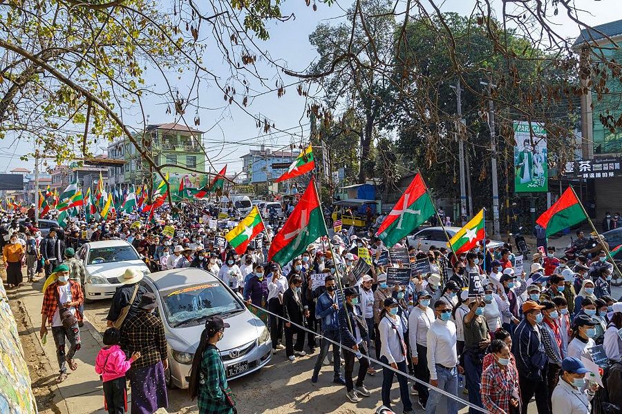 Protesters take part in a demonstration against the military coup in Myanmar's Muse, a town near the border with China, on 22 February 2021. (STR/AFP)