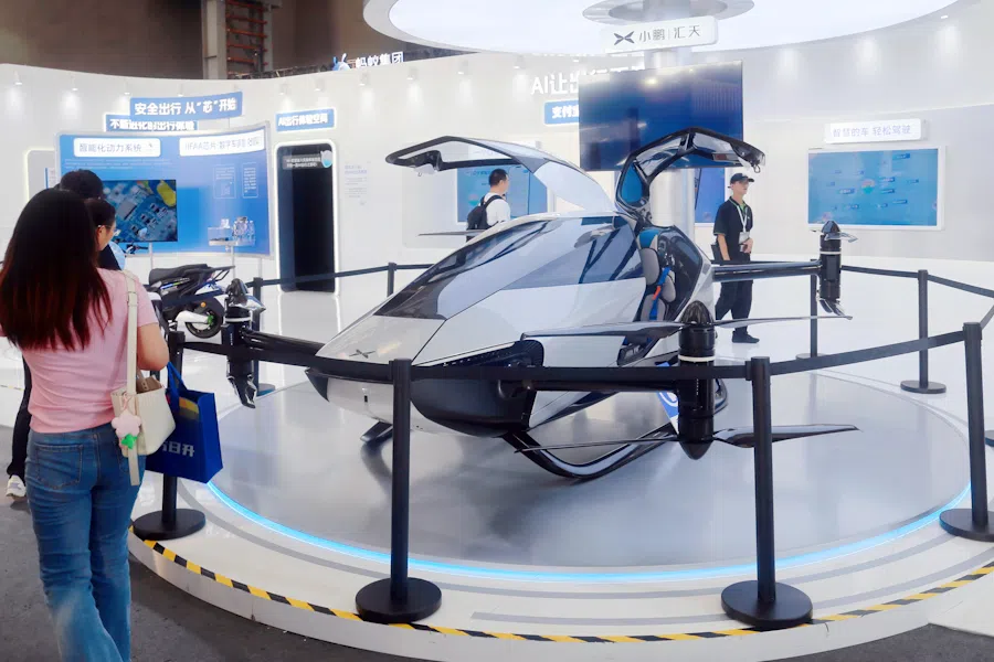 Visitors visit the Xiaopeng two-person intelligent electric low-altitude Vehicle (flying car) in the Future Travel exhibition area at the INCLUSION·Conference on the Bund in Shanghai, China, on 7 September 2024.