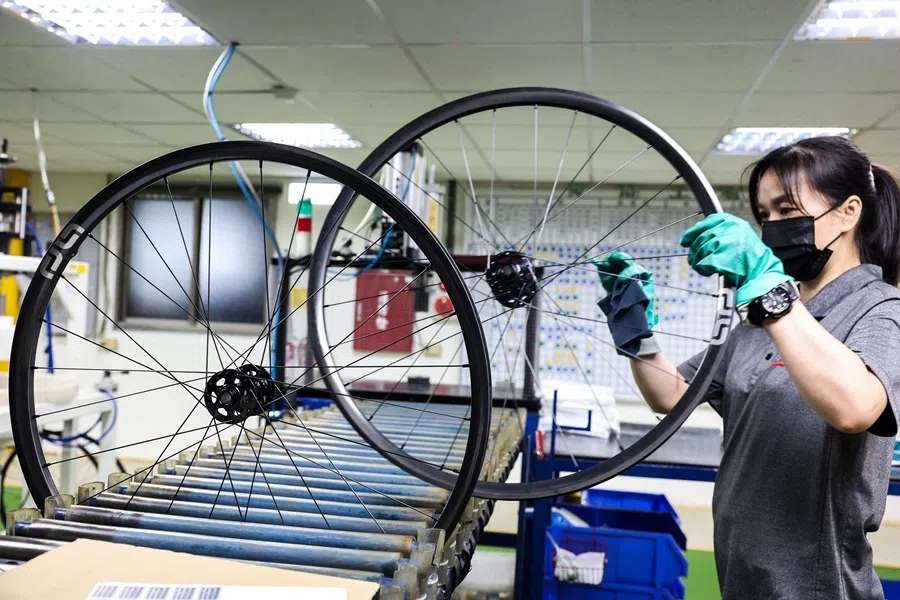 In this picture taken on 24 April 2025, a worker checks bicycle wheels at a factory of Joy Group in Taichung, Taiwan. (I-Hwa Cheng/AFP)