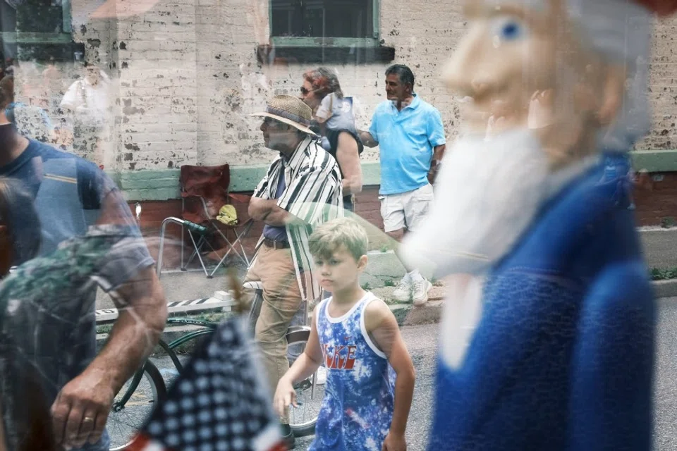 People watch the annual Fourth of July parade on 4 July 2021 in Saugerties, New York. (Spencer Platt/Getty Images/AFP)