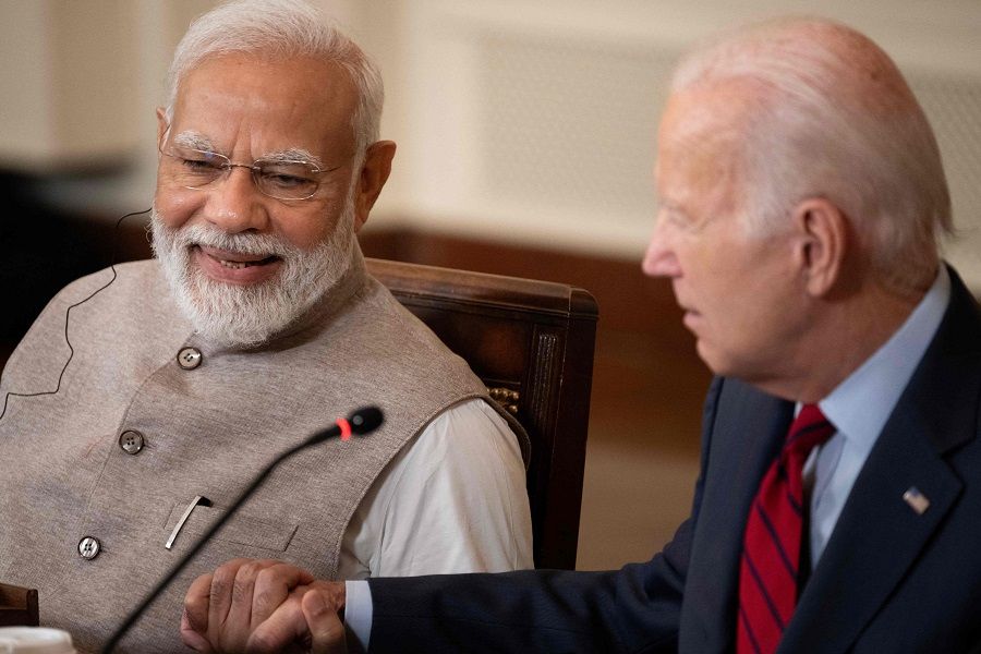 India's Prime Minister Narendra Modi and US President Joe Biden embrace hands during a meeting with senior officials and CEOs of American and Indian companies, in the East Room at the White House in Washington, DC, US, on 23 June 2023. (Brendan Smialowski/AFP)