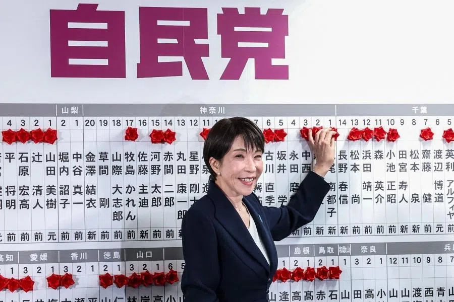 Japan’s Prime Minister and President of the Liberal Democratic Party (LDP) Sanae Takaichi places a red paper rose on the name of an elected candidate at the LDP headquarters during the House of Representatives election in Tokyo on 8 February 2026.