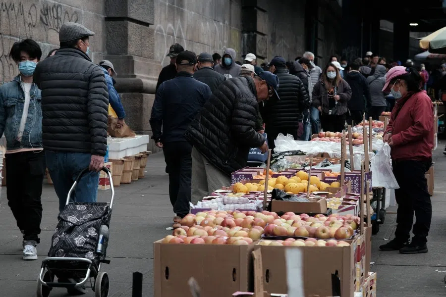 People walk through a busy shopping district only a block away from a building that is suspected of being used as a secret police station in Chinatown for the purpose of repressing dissidents living in the United States on behalf of the Chinese government on 18 April 2023 in New York City. (Spencer Platt/Getty Images/AFP)